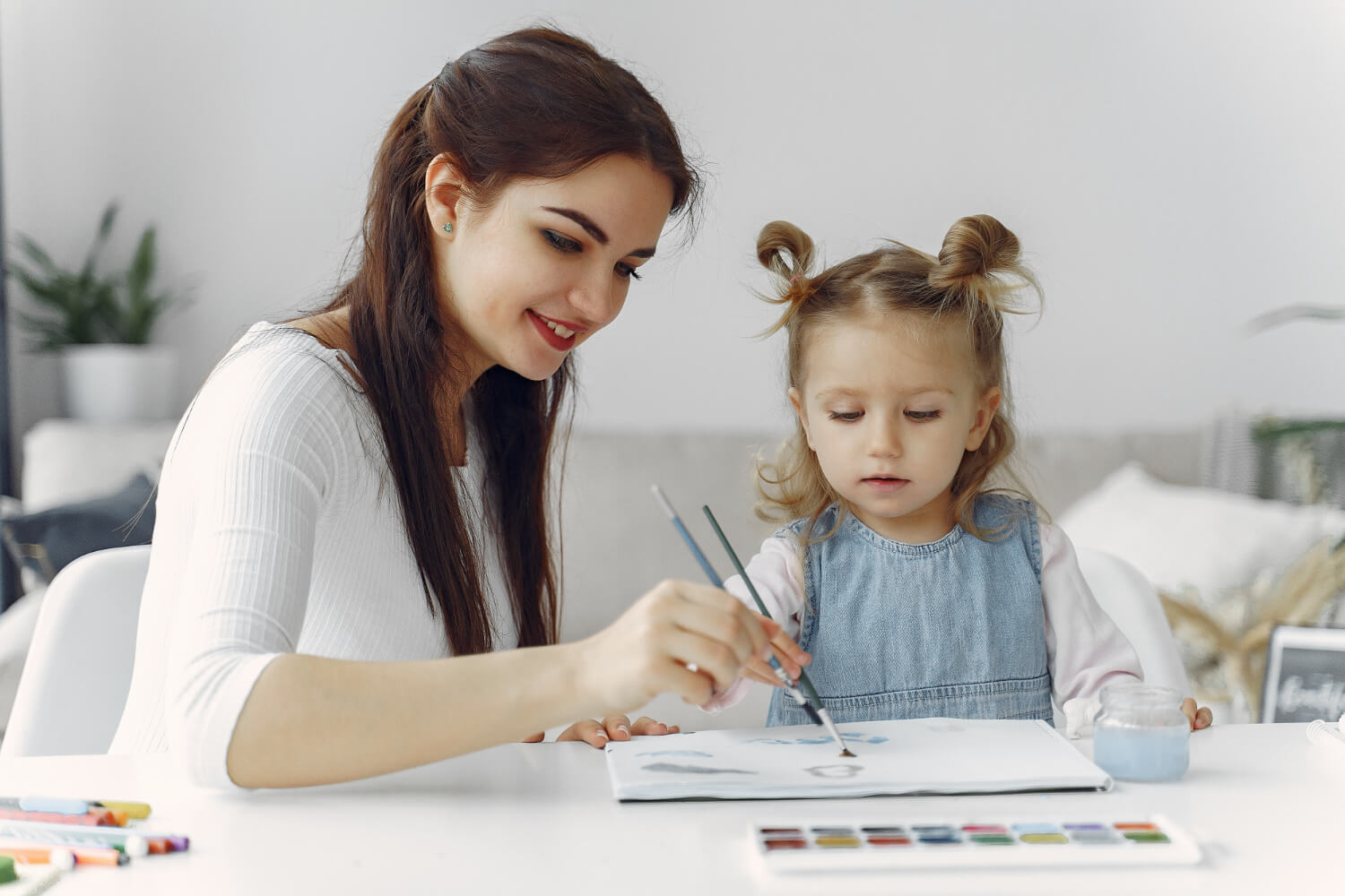 tutor with little girl studying at home