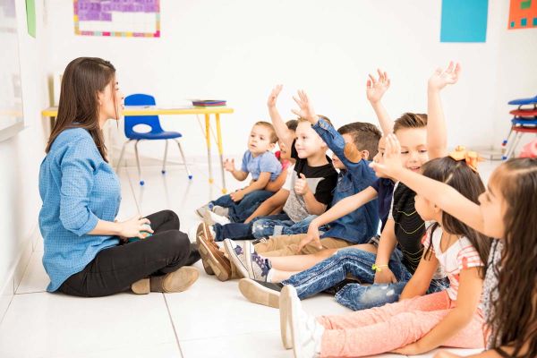 Preschool teacher in front of a group of toddlers