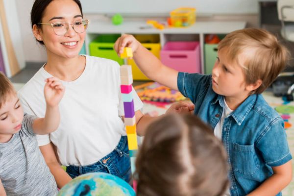 Nursery teacher with children